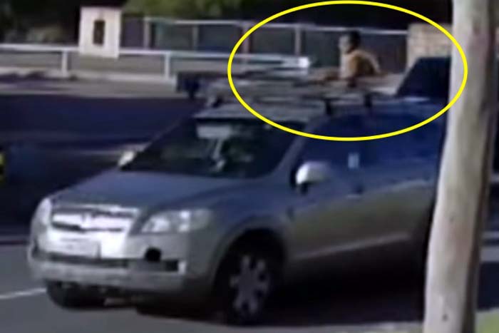 Mulher é flagrada dirigindo com filho em cima do teto de carro 